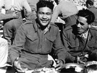 A fond farewell A big smile from W Eratara as he sits down to Christmas Dinner, Maadi Camp, Egypt, 1943. Image courtesy of Army Museum